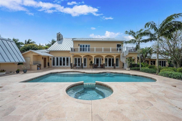 view of pool featuring an in ground hot tub and a patio