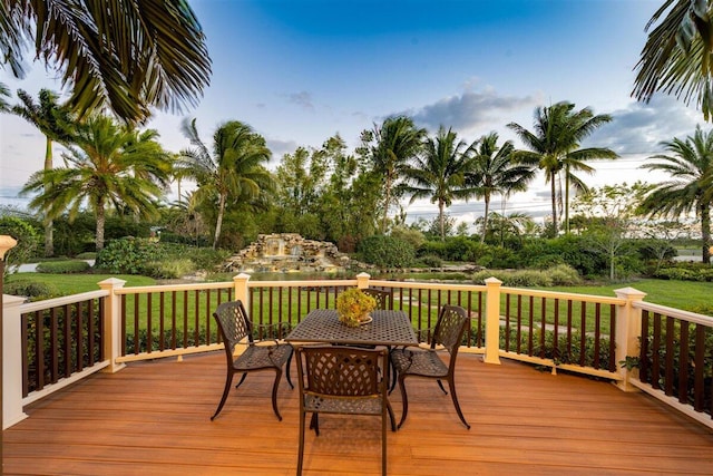 wooden deck featuring a lawn