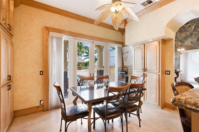 dining space featuring light tile flooring, ornamental molding, ceiling fan, and french doors