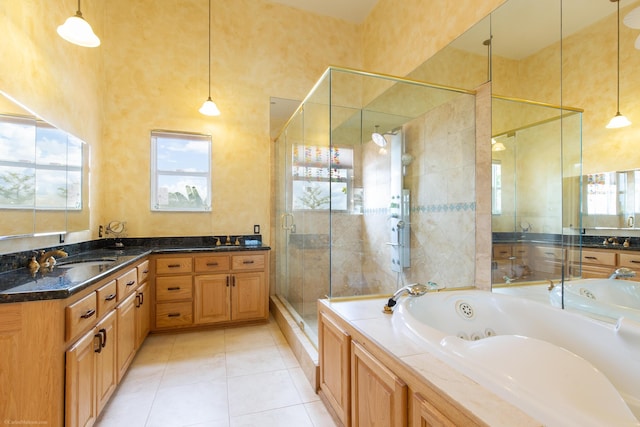 bathroom with independent shower and bath, double vanity, and tile flooring