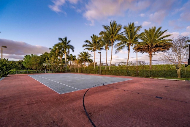 view of tennis court with basketball hoop