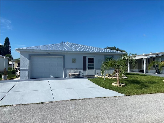 view of front of property with a front lawn and a garage