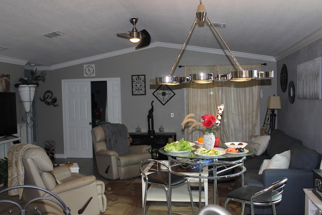 living room with a textured ceiling, crown molding, ceiling fan, and vaulted ceiling