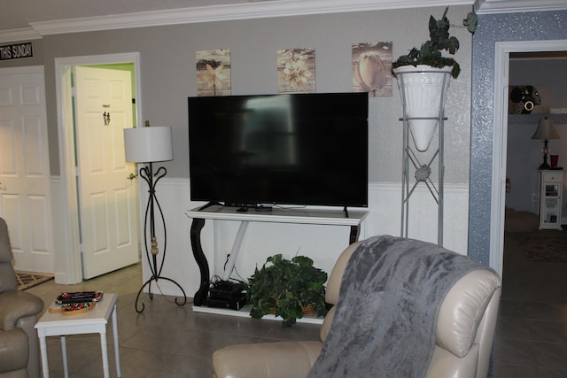 living room featuring ornamental molding and dark tile flooring