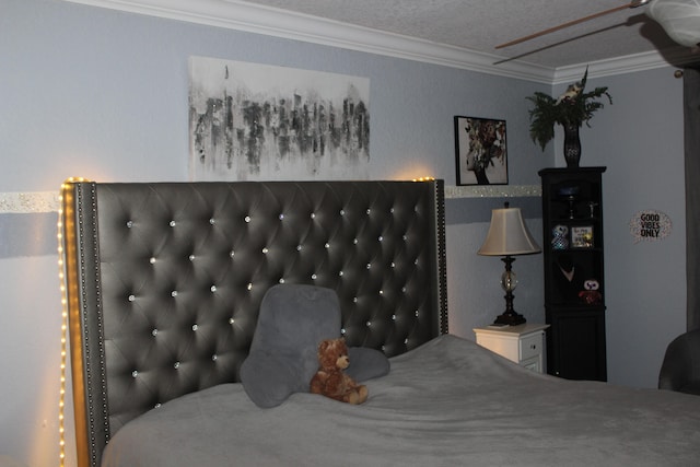 bedroom with a textured ceiling and crown molding