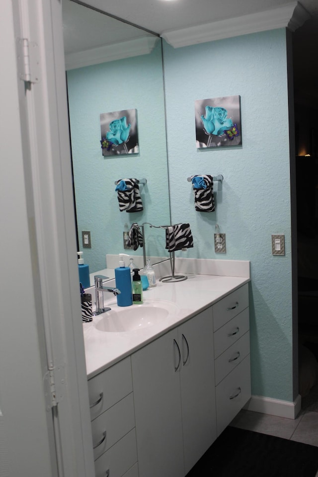 bathroom with ornamental molding, tile floors, and vanity