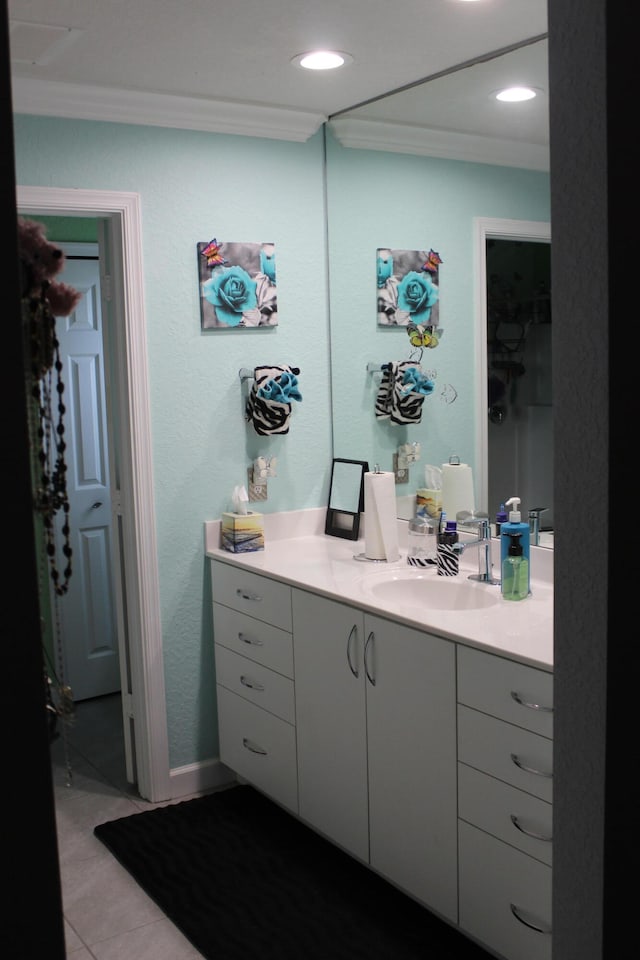 bathroom featuring tile floors, oversized vanity, and crown molding