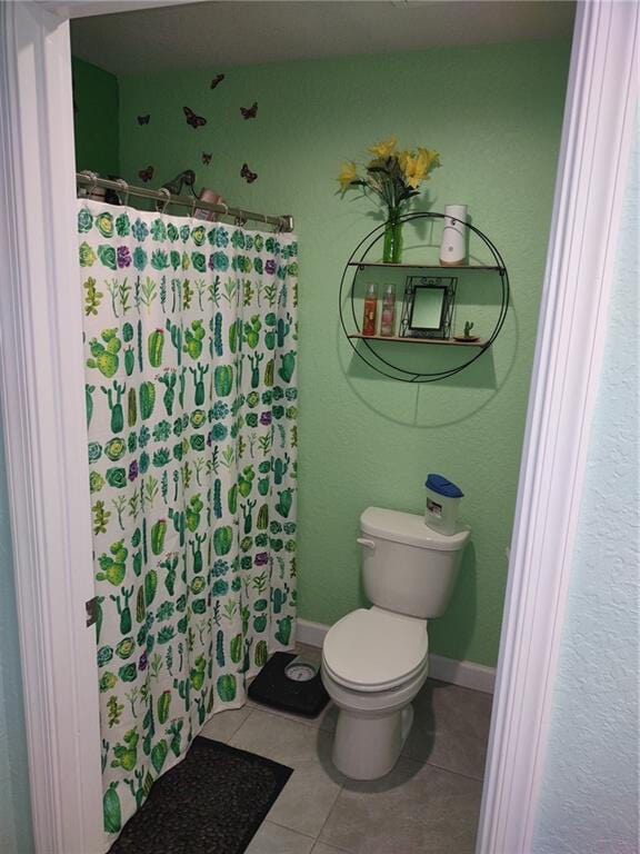 bathroom with toilet and tile flooring