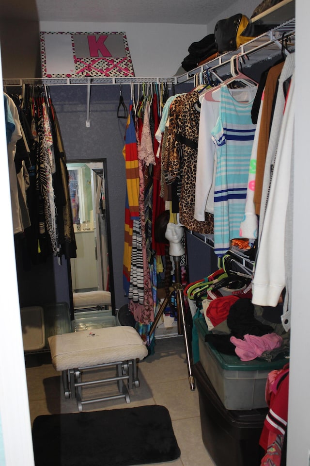 spacious closet featuring light tile floors