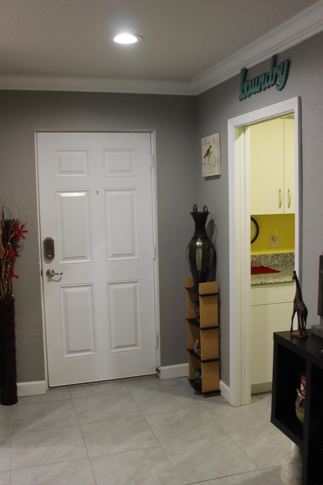 tiled foyer entrance with crown molding