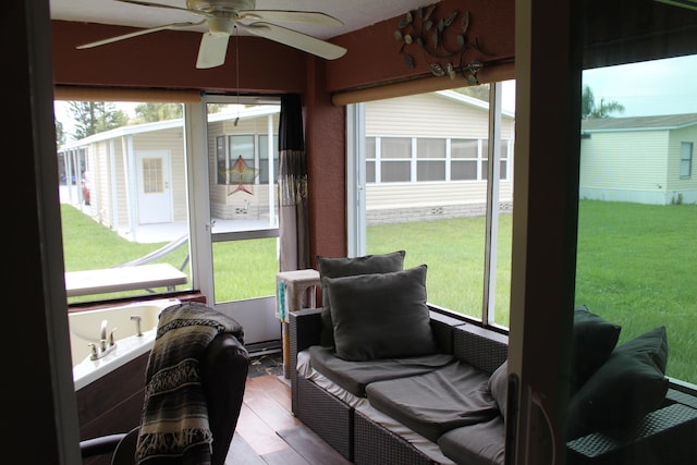 sunroom / solarium with plenty of natural light and ceiling fan