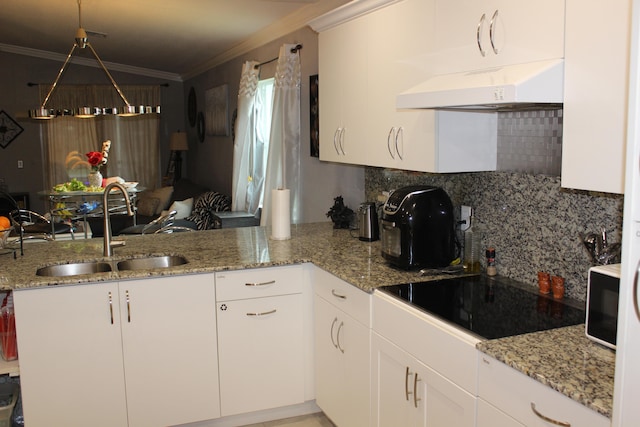 kitchen with kitchen peninsula, sink, white cabinets, custom range hood, and black electric stovetop