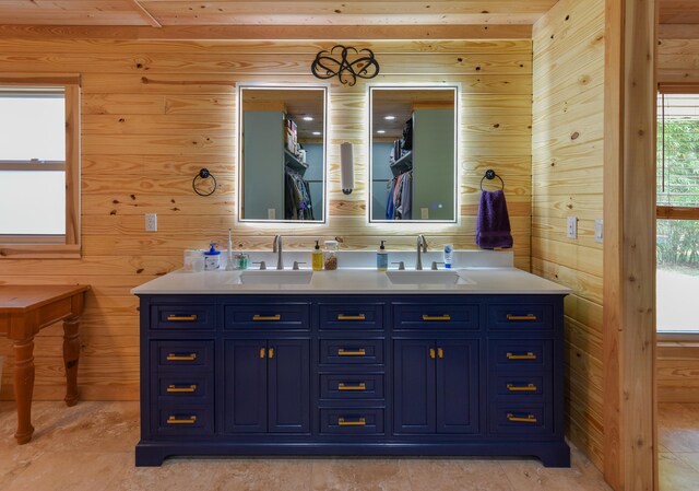 bathroom featuring vanity and wood walls