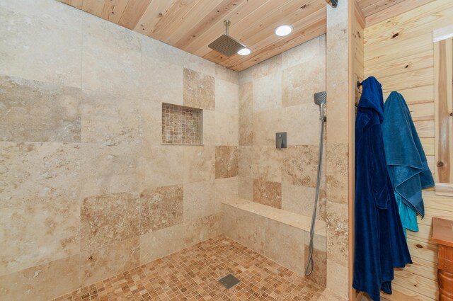 bathroom with wood ceiling and tiled shower