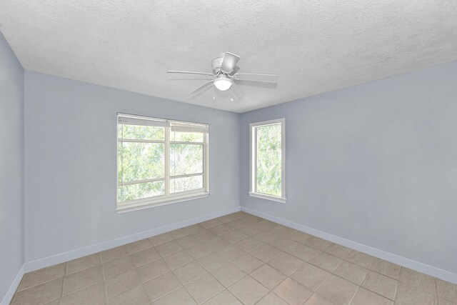 unfurnished room featuring a textured ceiling and ceiling fan