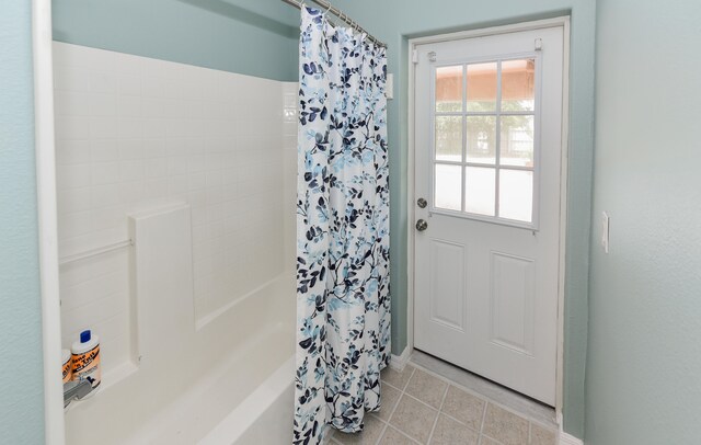 doorway to outside with light tile patterned floors