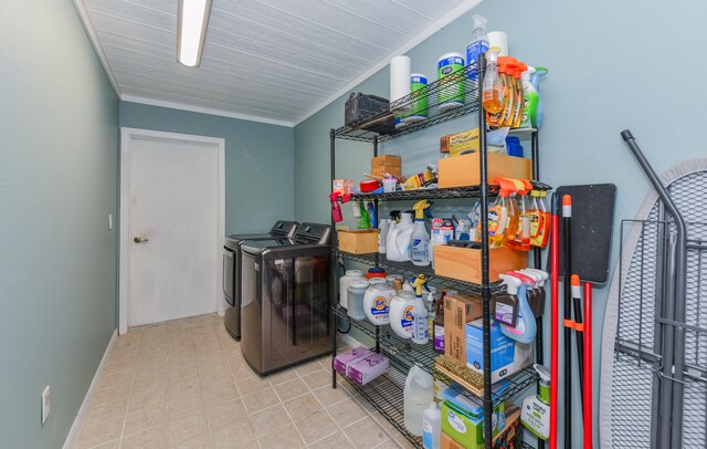 washroom featuring ornamental molding and washing machine and clothes dryer