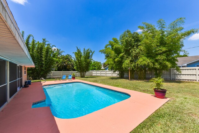 view of pool featuring a patio area and a lawn