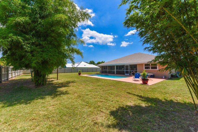 view of yard featuring a fenced in pool and a patio