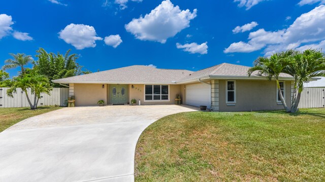 ranch-style home featuring a garage and a front lawn