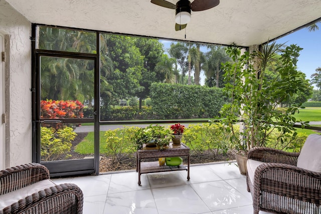 sunroom / solarium featuring ceiling fan