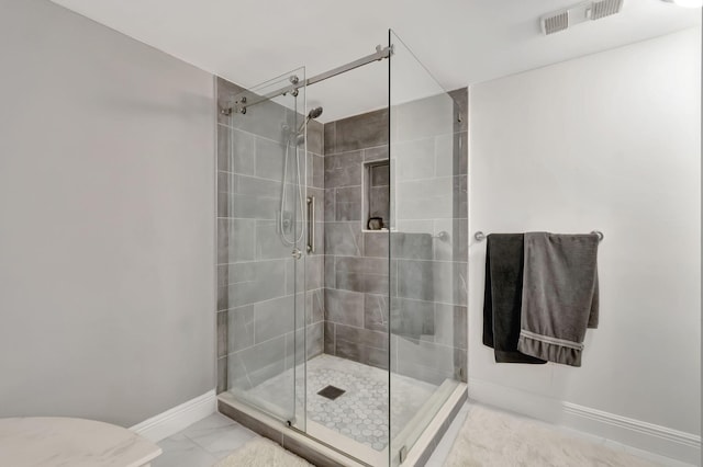 bathroom featuring a shower with shower door