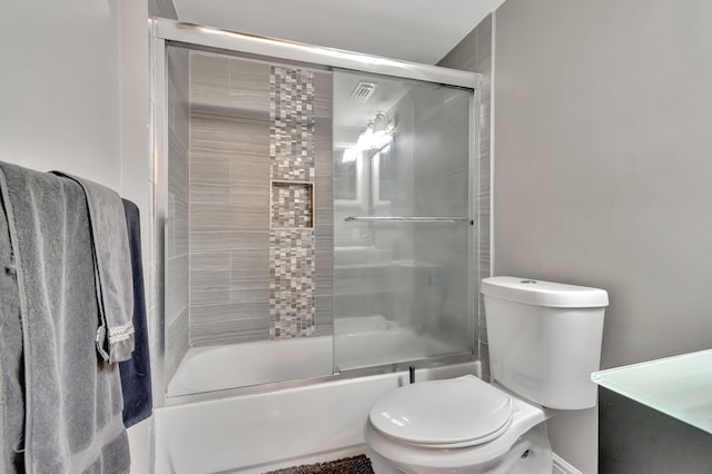 bathroom with toilet and enclosed tub / shower combo