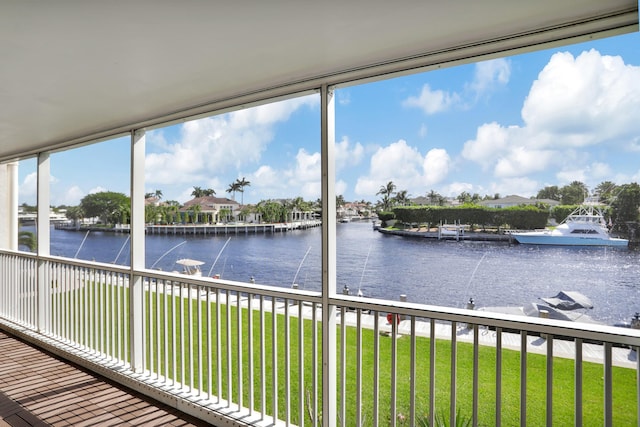 unfurnished sunroom with a water view