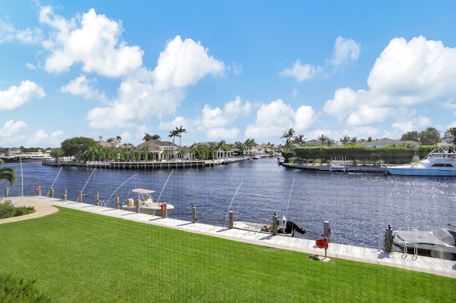 view of dock with a water view and a lawn