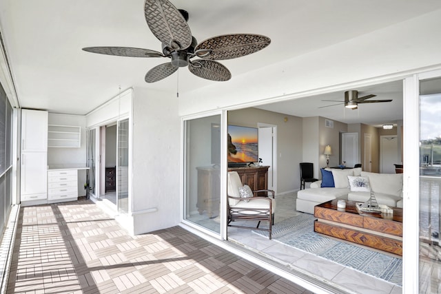 sunroom / solarium with ceiling fan