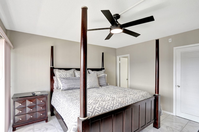 bedroom with ceiling fan and light tile floors