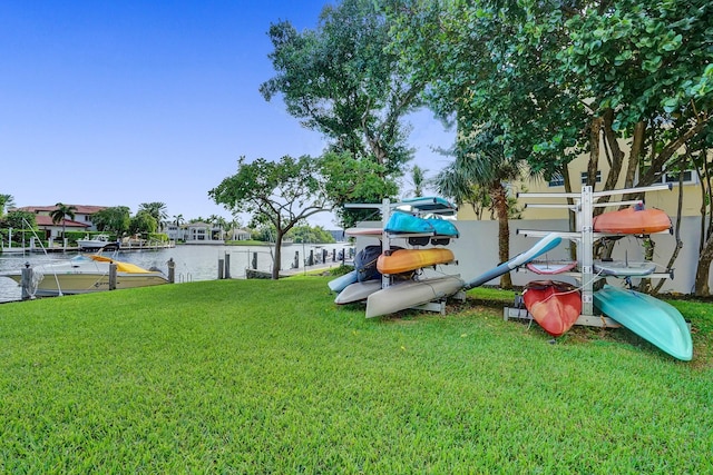 view of yard featuring a water view and a dock