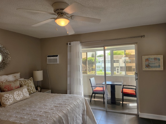 tiled bedroom with ceiling fan, a textured ceiling, and a wall mounted AC