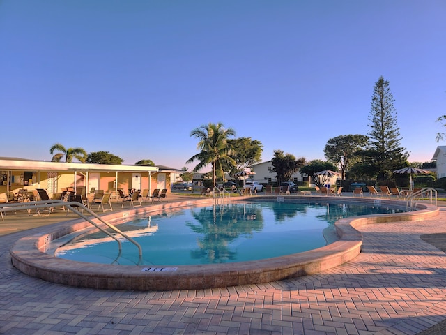 view of pool with a jacuzzi and a patio