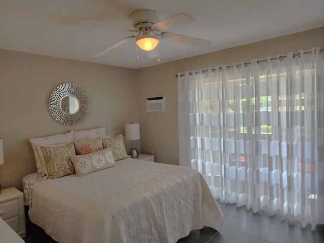 bedroom featuring ceiling fan, tile flooring, and a wall unit AC