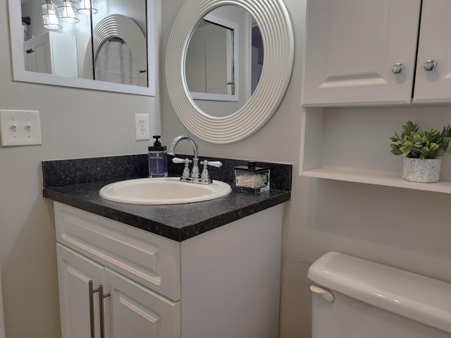 bathroom featuring large vanity and toilet