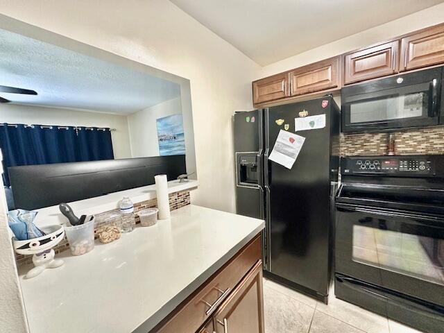 kitchen with light tile floors and black appliances