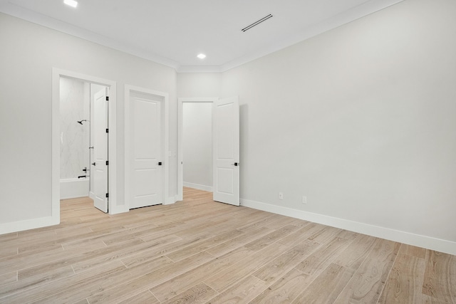 unfurnished bedroom with light wood-type flooring and crown molding