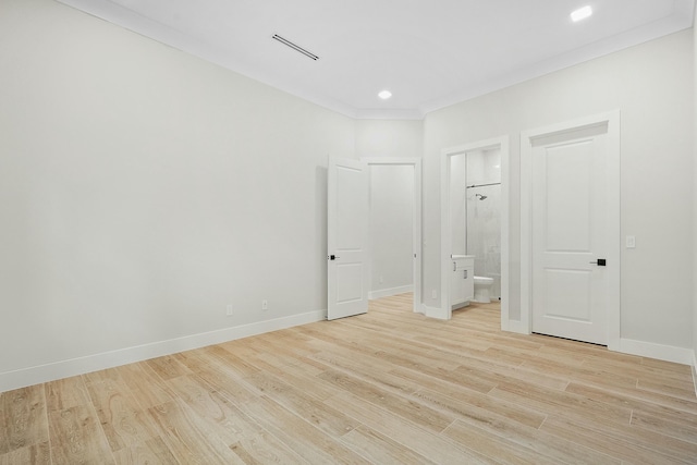 interior space with light hardwood / wood-style floors and crown molding