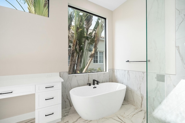 bathroom featuring a tub and a wealth of natural light