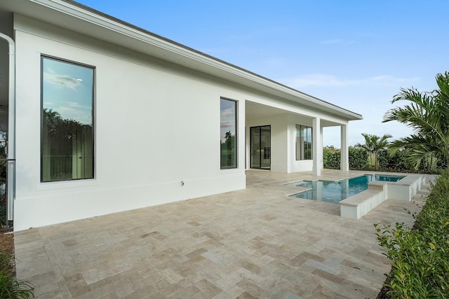 view of pool featuring a patio area and a hot tub