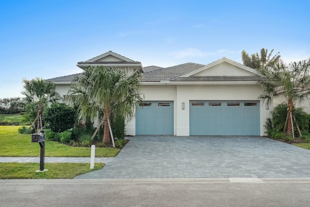 view of front facade featuring a front yard and a garage