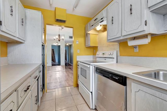 kitchen featuring electric range, hanging light fixtures, stainless steel dishwasher, a chandelier, and light tile patterned flooring