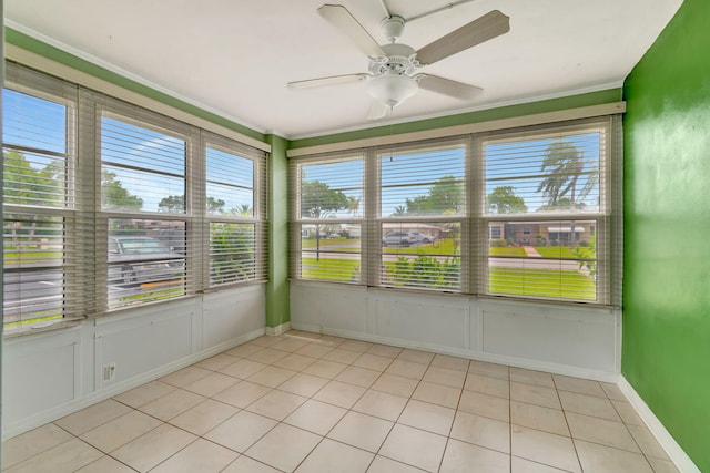 unfurnished sunroom featuring ceiling fan