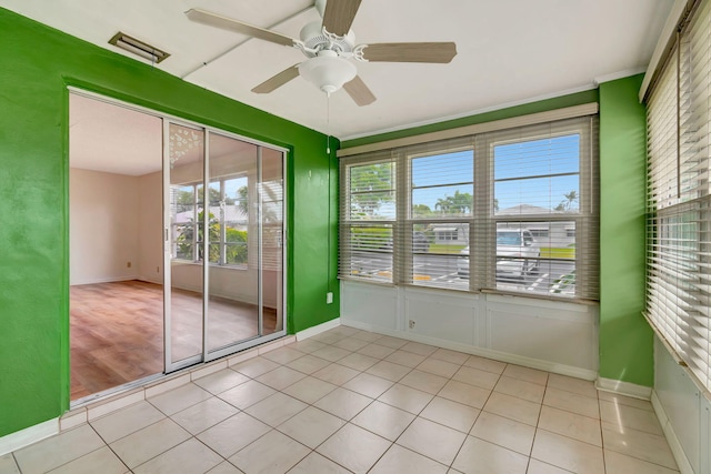 interior space with ceiling fan