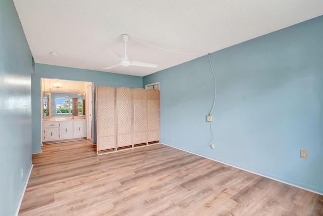 unfurnished bedroom with ceiling fan, a textured ceiling, and light wood-type flooring