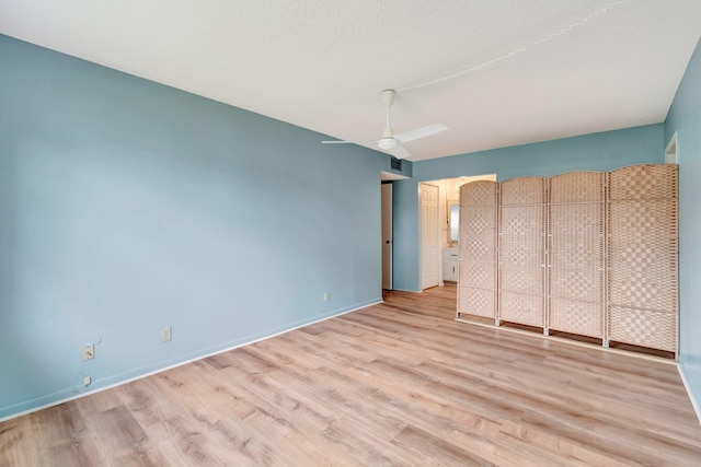 unfurnished bedroom featuring ceiling fan, light hardwood / wood-style flooring, and a textured ceiling