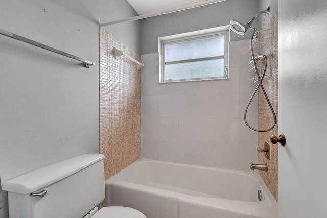 bathroom featuring tiled shower / bath and toilet