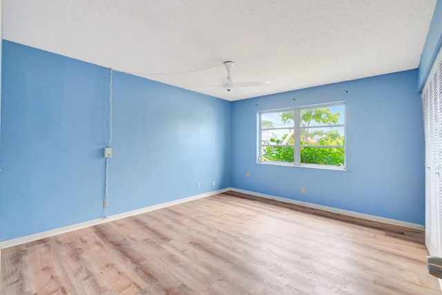 unfurnished room featuring a textured ceiling, light hardwood / wood-style floors, and ceiling fan