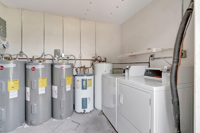 clothes washing area with washer and dryer and water heater